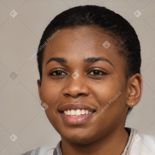 Joyful black young-adult female with short  black hair and brown eyes