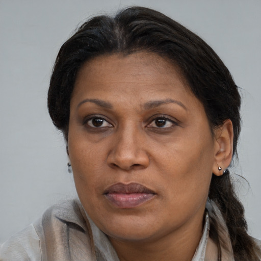 Joyful black adult female with medium  brown hair and brown eyes