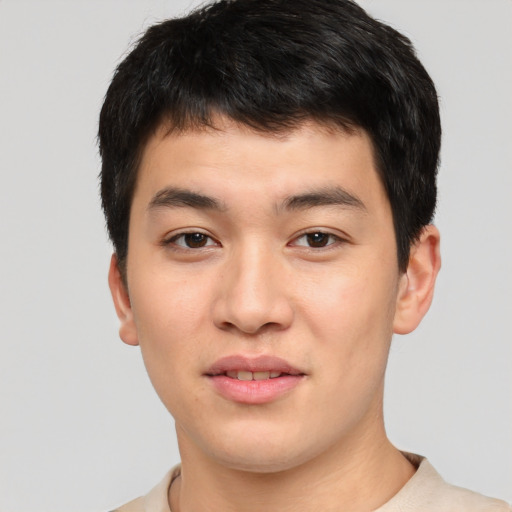 Joyful asian young-adult male with short  brown hair and brown eyes