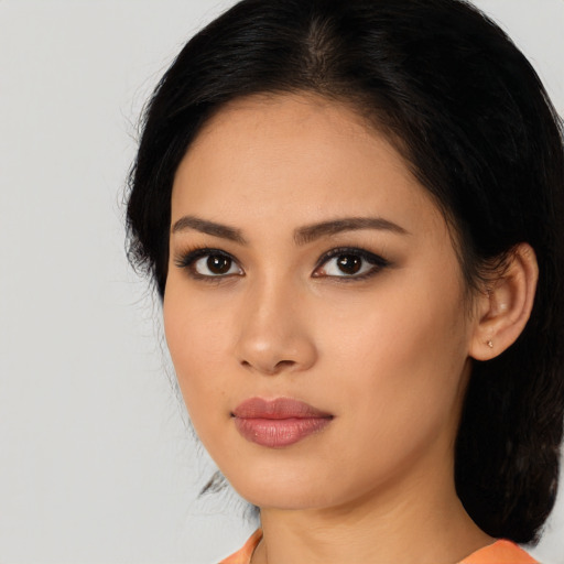 Joyful latino young-adult female with medium  black hair and brown eyes