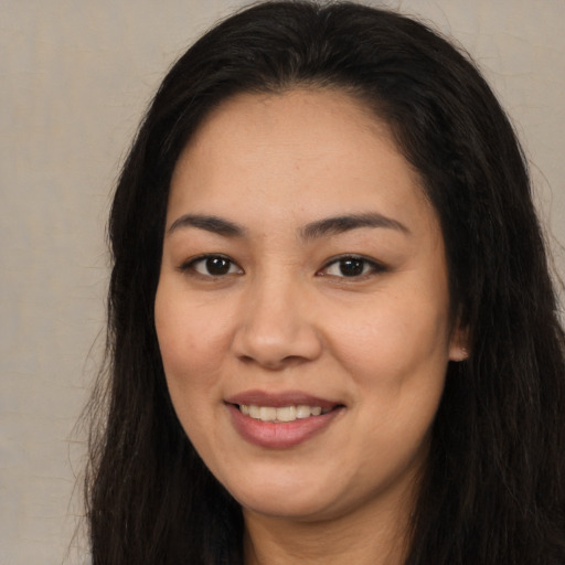 Joyful asian young-adult female with long  brown hair and brown eyes