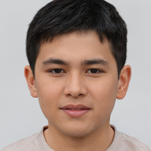 Joyful asian child male with short  brown hair and brown eyes