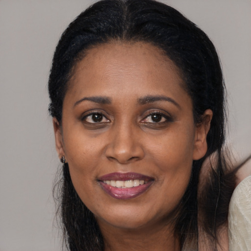 Joyful latino adult female with long  black hair and brown eyes