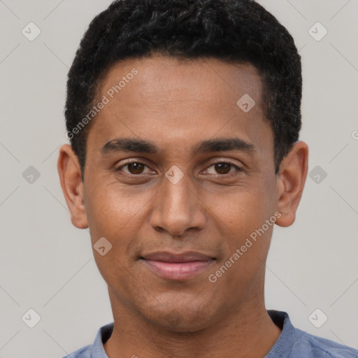 Joyful black young-adult male with short  brown hair and brown eyes