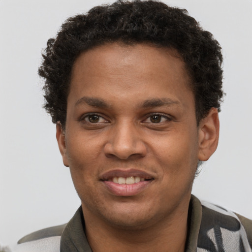 Joyful black young-adult male with short  brown hair and brown eyes
