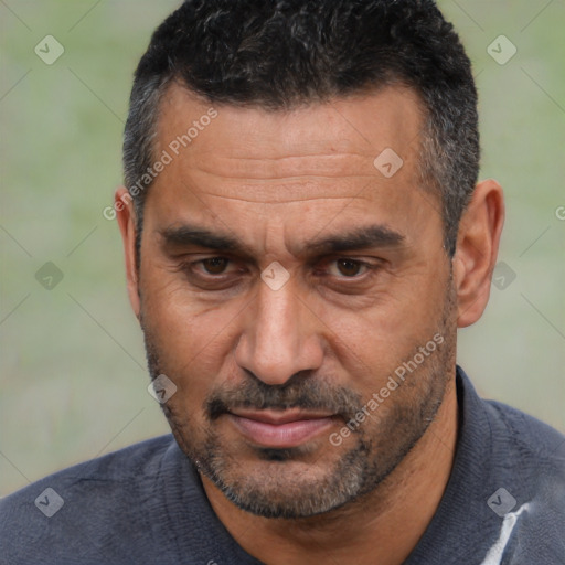 Joyful white adult male with short  black hair and brown eyes