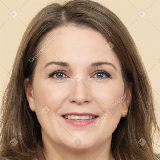 Joyful white adult female with long  brown hair and brown eyes