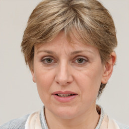 Joyful white adult female with medium  brown hair and grey eyes