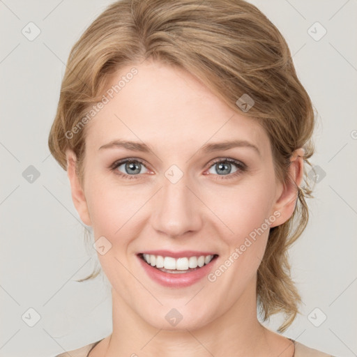 Joyful white young-adult female with medium  brown hair and green eyes