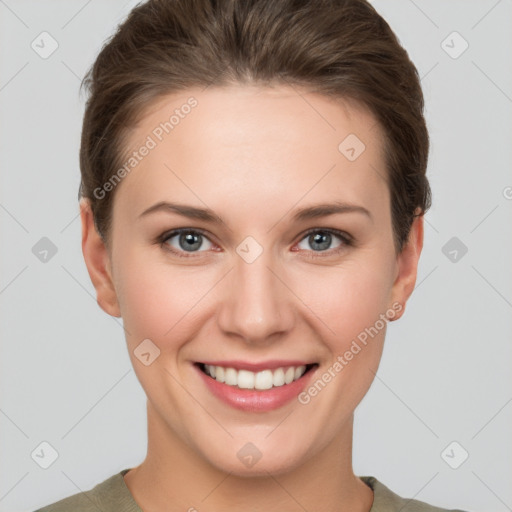 Joyful white young-adult female with short  brown hair and grey eyes