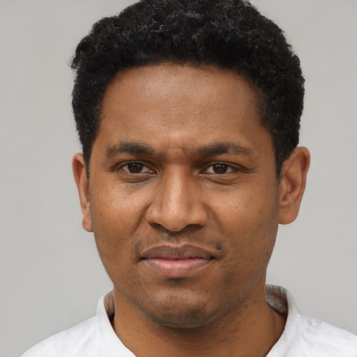 Joyful latino adult male with short  black hair and brown eyes