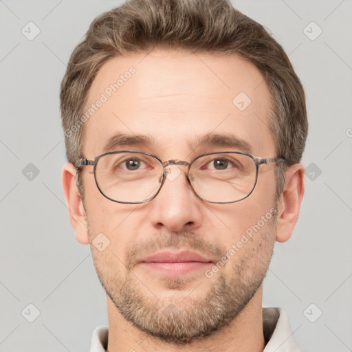 Joyful white adult male with short  brown hair and grey eyes