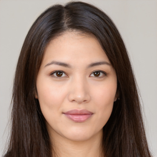 Joyful asian young-adult female with long  brown hair and brown eyes