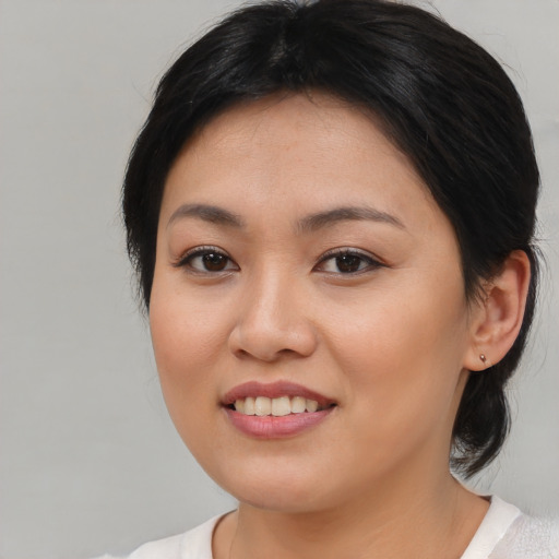Joyful white young-adult female with medium  brown hair and brown eyes