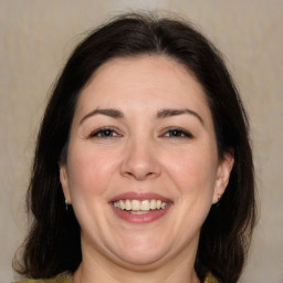 Joyful white adult female with medium  brown hair and brown eyes