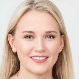 Joyful white young-adult female with long  brown hair and blue eyes