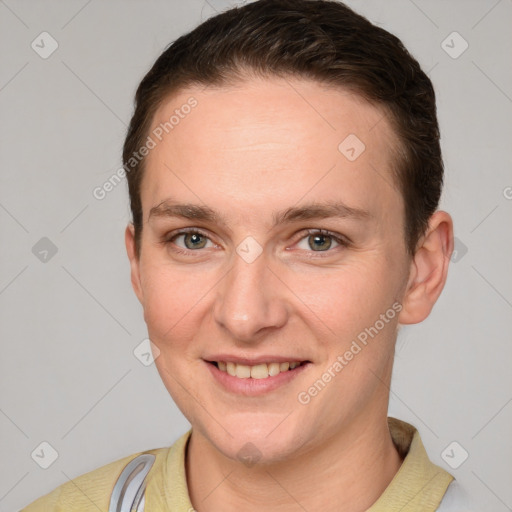 Joyful white young-adult female with short  brown hair and grey eyes