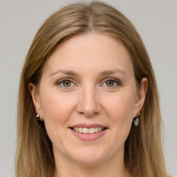 Joyful white adult female with long  brown hair and grey eyes