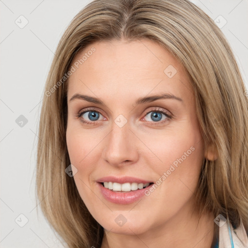 Joyful white young-adult female with medium  brown hair and blue eyes