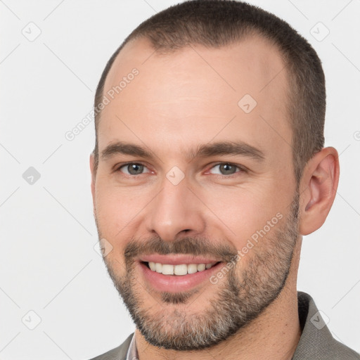 Joyful white young-adult male with short  brown hair and brown eyes