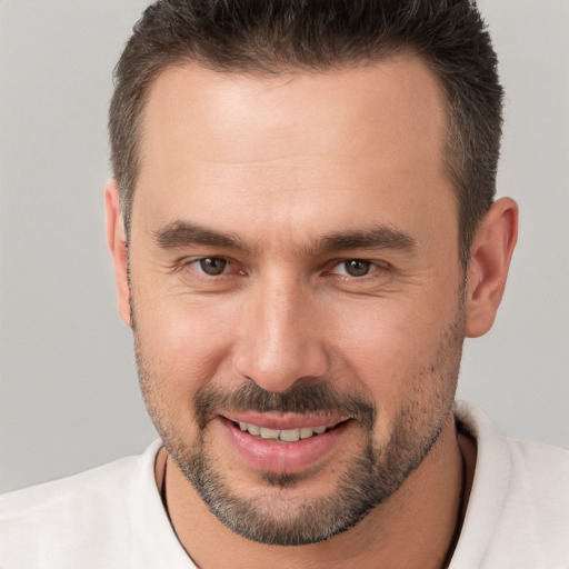 Joyful white young-adult male with short  brown hair and brown eyes