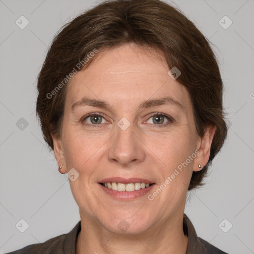 Joyful white adult female with medium  brown hair and grey eyes