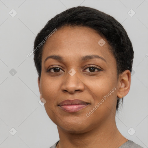 Joyful black young-adult female with short  black hair and brown eyes