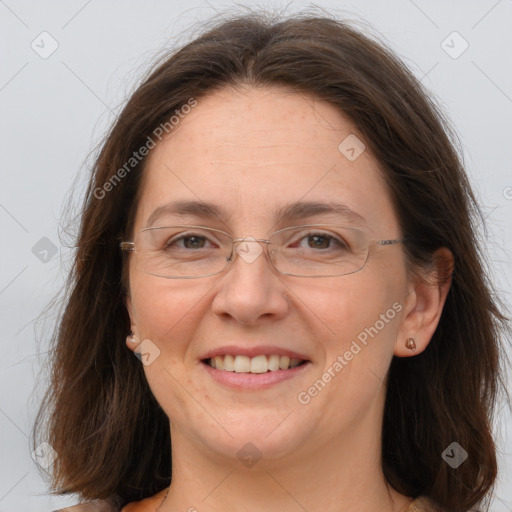 Joyful white adult female with long  brown hair and brown eyes