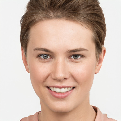 Joyful white young-adult female with short  brown hair and grey eyes