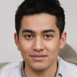 Joyful asian young-adult male with short  black hair and brown eyes