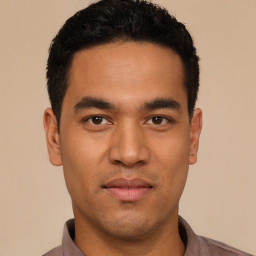 Joyful latino young-adult male with short  black hair and brown eyes