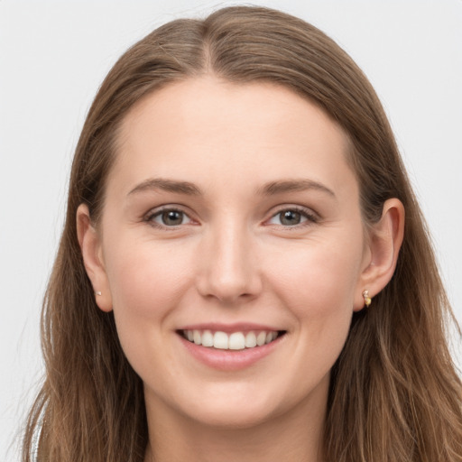 Joyful white young-adult female with long  brown hair and grey eyes