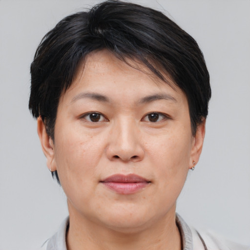 Joyful asian adult female with short  brown hair and brown eyes