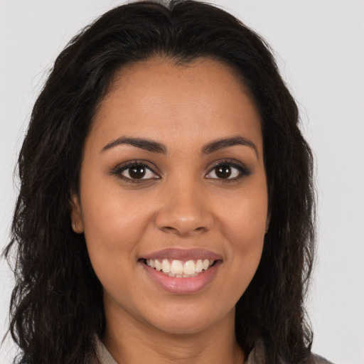 Joyful latino young-adult female with long  brown hair and brown eyes