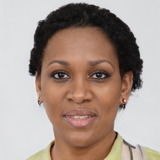Joyful black adult female with short  black hair and brown eyes