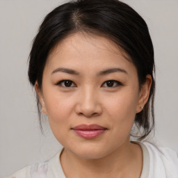 Joyful asian young-adult female with medium  brown hair and brown eyes