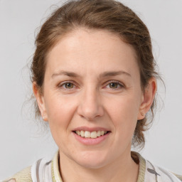 Joyful white adult female with medium  brown hair and grey eyes