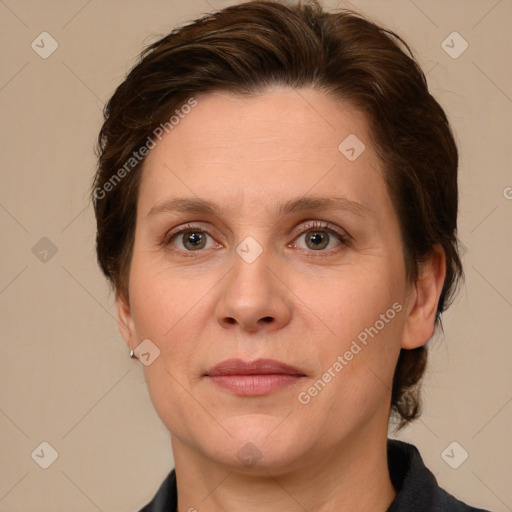 Joyful white adult female with medium  brown hair and grey eyes