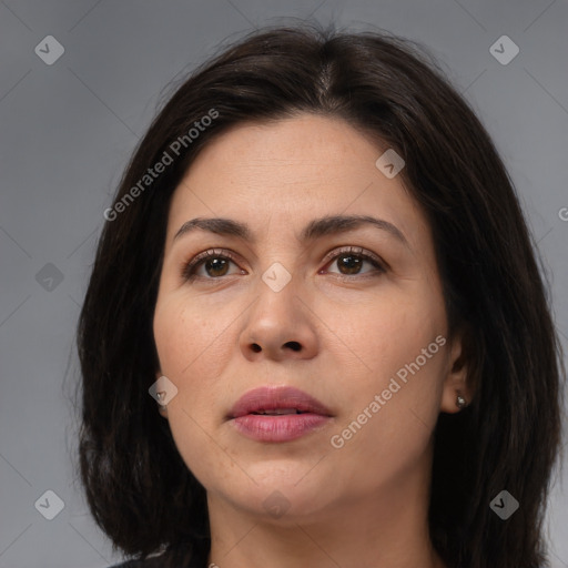 Joyful white adult female with long  brown hair and brown eyes