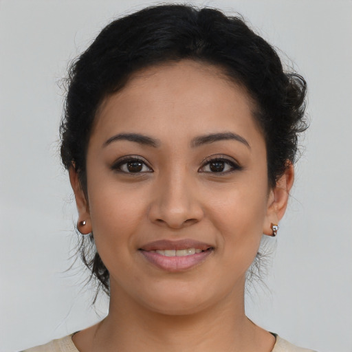 Joyful latino young-adult female with medium  brown hair and brown eyes