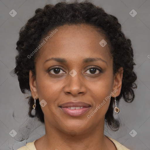 Joyful black adult female with medium  brown hair and brown eyes