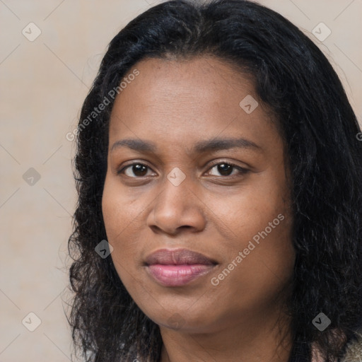 Joyful black young-adult female with long  black hair and brown eyes