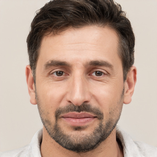 Joyful white adult male with short  brown hair and brown eyes