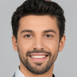 Joyful white young-adult male with short  black hair and brown eyes