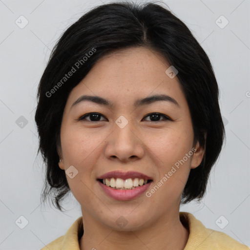 Joyful asian young-adult female with medium  black hair and brown eyes