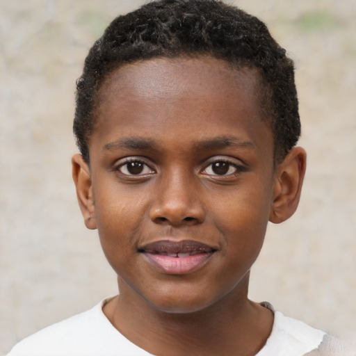 Joyful black child male with short  brown hair and brown eyes