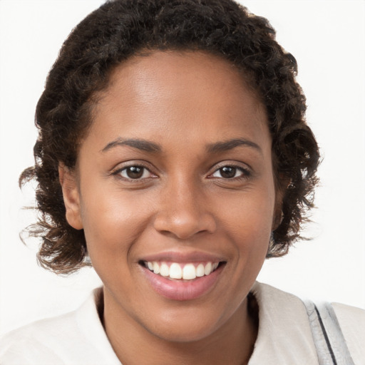 Joyful black young-adult female with medium  brown hair and brown eyes