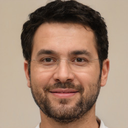 Joyful white adult male with short  brown hair and brown eyes