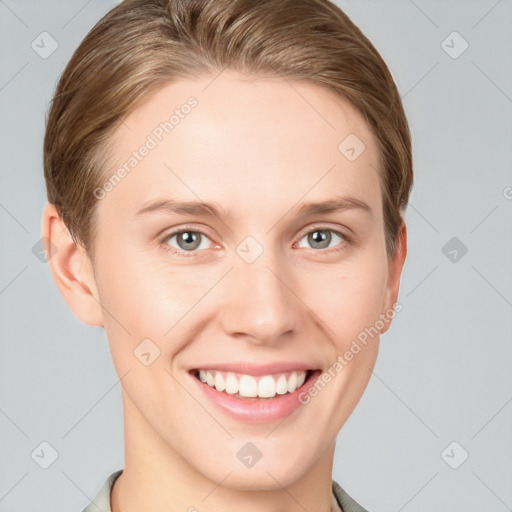 Joyful white young-adult female with short  brown hair and grey eyes