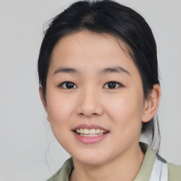 Joyful asian young-adult female with medium  black hair and brown eyes